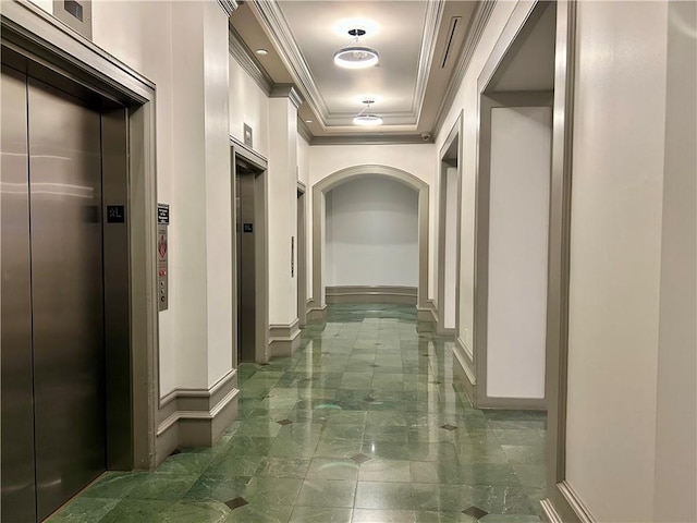 hall featuring crown molding, elevator, and a raised ceiling