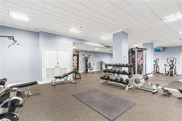 workout area with a paneled ceiling