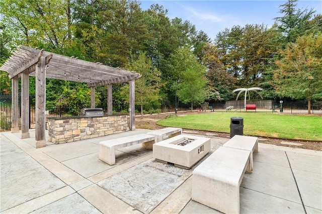 view of patio / terrace with a fire pit, an outdoor kitchen, and a pergola