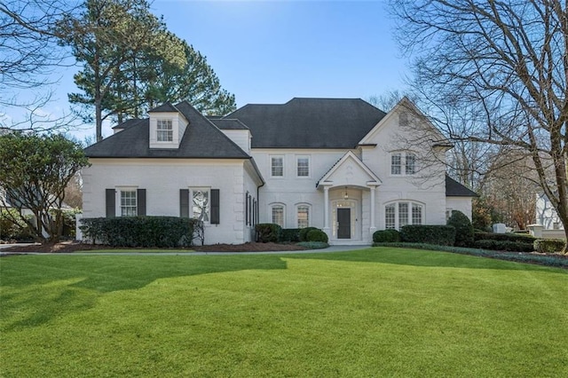 french provincial home featuring a front lawn