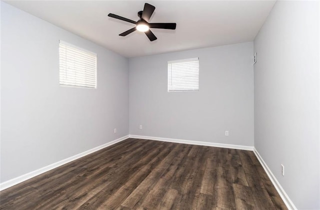 spare room with dark wood-type flooring and ceiling fan