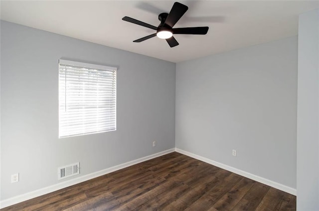 spare room featuring dark hardwood / wood-style floors and ceiling fan