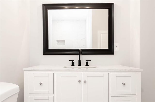 bathroom featuring toilet and vanity