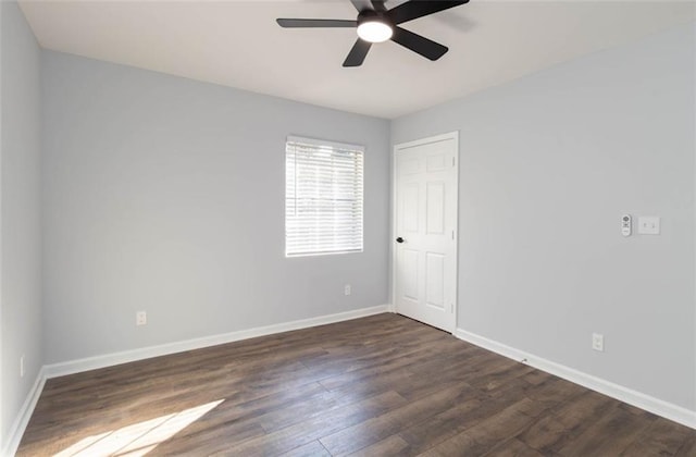 empty room with ceiling fan and dark hardwood / wood-style flooring