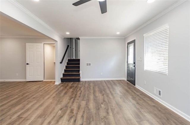 unfurnished living room with ornamental molding, wood-type flooring, and ceiling fan