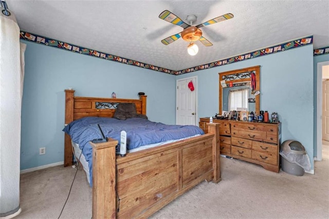 bedroom featuring baseboards, a textured ceiling, ceiling fan, and carpet