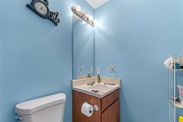 bathroom with toilet and vanity