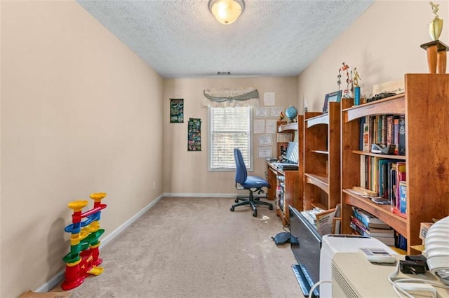 office with carpet flooring, a textured ceiling, and baseboards