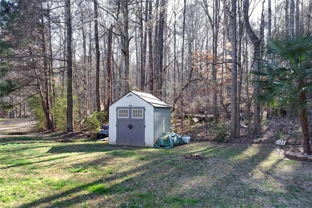 view of shed with a wooded view