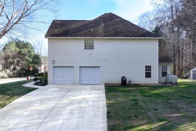 view of side of home with a garage, a lawn, concrete driveway, and a shingled roof