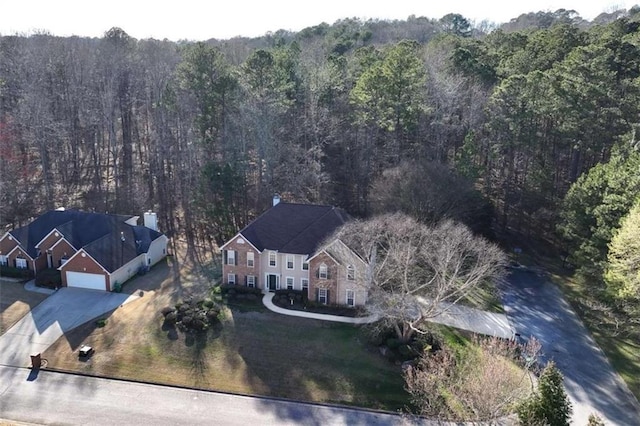 birds eye view of property with a view of trees