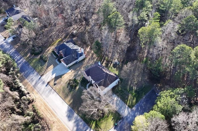 birds eye view of property with a wooded view