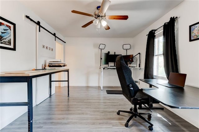 4417 Village Square Ln, Stone Mountain, GA 30083 - office with light wood-type flooring, ceiling fan, and a barn door