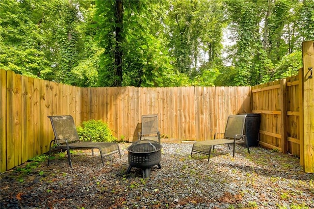 4417 Village Square Ln, Stone Mountain, GA 30083 - fenced backyard featuring an outdoor fire pit