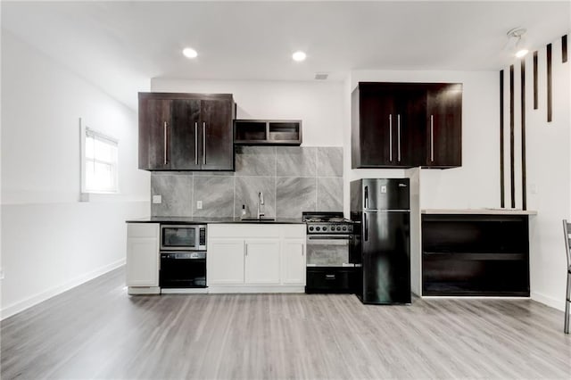 4417 Village Square Ln, Stone Mountain, GA 30083 - kitchen featuring freestanding refrigerator, stainless steel microwave, gas range, and light wood finished floors