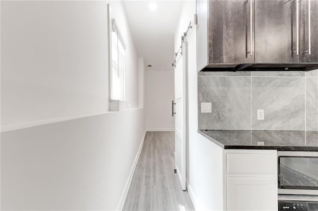 4417 Village Square Ln, Stone Mountain, GA 30083 - hall featuring light wood finished floors, a barn door, and beverage cooler