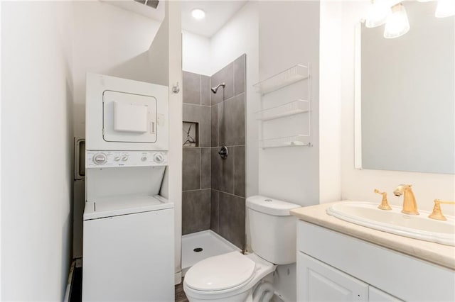 4417 Village Square Ln, Stone Mountain, GA 30083 - bathroom featuring stacked washer and clothes dryer, vanity, and tiled shower