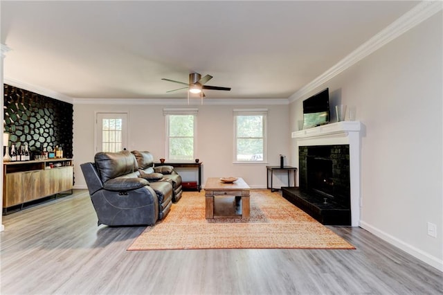 4417 Village Square Ln, Stone Mountain, GA 30083 - living room with wood finished floors, ceiling fan, a premium fireplace, crown molding, and bar