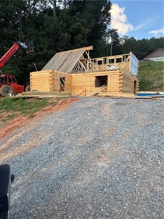 196 Mountain Trce, Ellijay, GA 30540 - view of front of house featuring a forest view, a deck, log siding, and metal roof