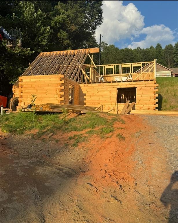 196 Mountain Trce, Ellijay, GA 30540 - view of front of property with log siding, stairs, and metal roof