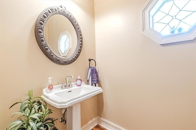 bathroom with hardwood / wood-style flooring and a healthy amount of sunlight