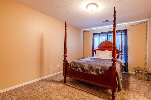 carpeted bedroom with a textured ceiling