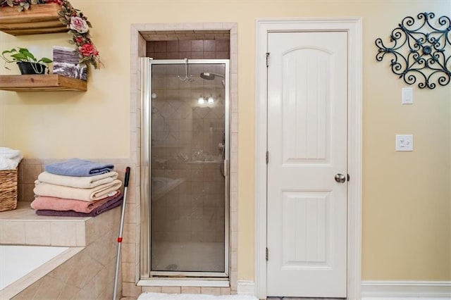 bathroom featuring a shower with shower door