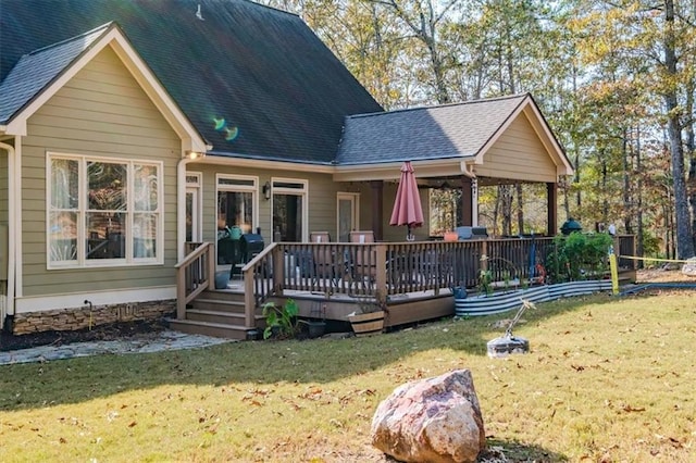 back of property with a lawn and a wooden deck