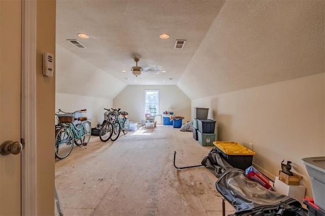 bonus room featuring ceiling fan, lofted ceiling, and a textured ceiling