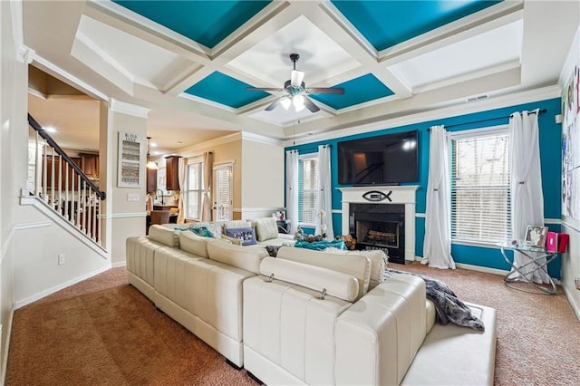 living room with coffered ceiling, ornamental molding, ceiling fan, and carpet flooring