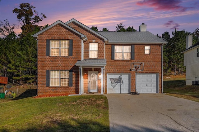 view of front facade featuring a yard, cooling unit, and a garage