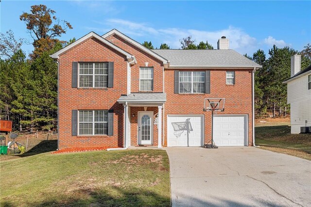 view of front of property with a front lawn, cooling unit, and a garage