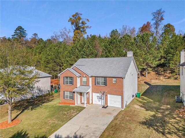 view of front of house with a front yard and a garage