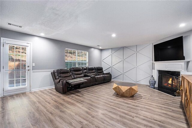 living room featuring a textured ceiling and hardwood / wood-style flooring