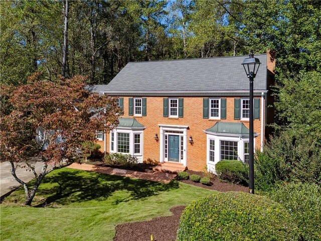 colonial home with a front yard