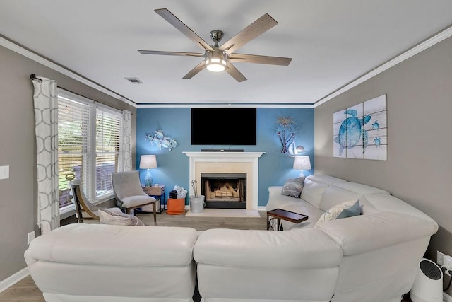 3202 Ivy Station Way, Duluth, GA 30096 - living area featuring wood finished floors, a ceiling fan, ornamental molding, a fireplace with flush hearth, and baseboards