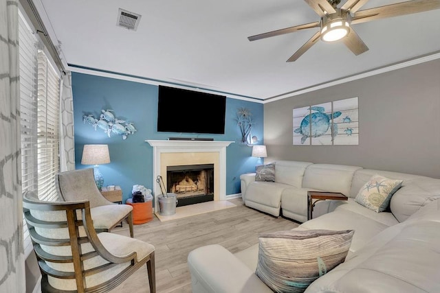 3202 Ivy Station Way, Duluth, GA 30096 - living area with ceiling fan, wood finished floors, a fireplace with flush hearth, crown molding, and plenty of natural light
