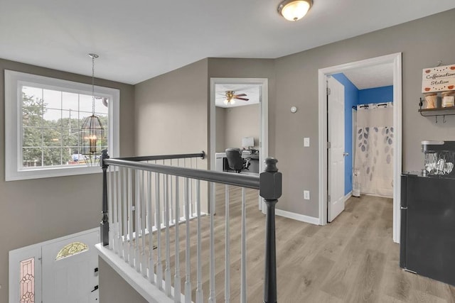 3202 Ivy Station Way, Duluth, GA 30096 - hallway featuring light wood-style floors, baseboards, and a chandelier