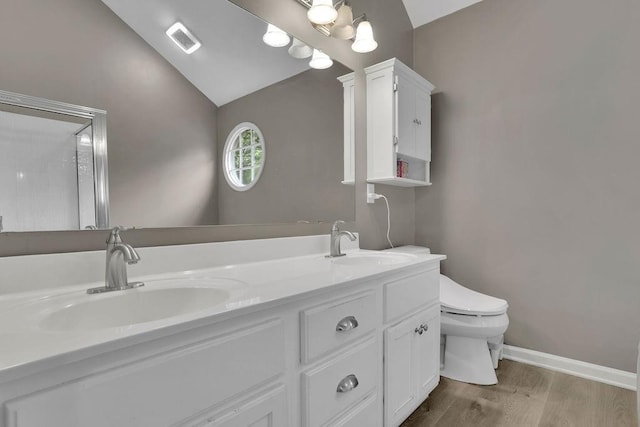 3202 Ivy Station Way, Duluth, GA 30096 - bathroom with lofted ceiling, toilet, wood finished floors, double vanity, and baseboards