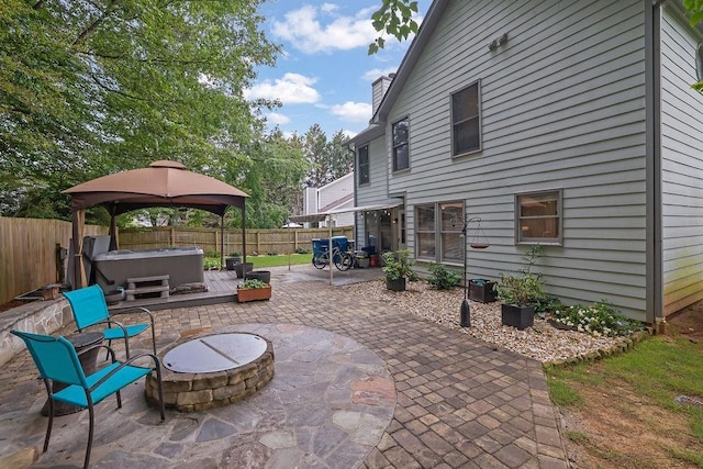 3202 Ivy Station Way, Duluth, GA 30096 - fenced backyard featuring a hot tub, a fire pit, a patio area, and a gazebo