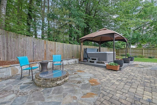 3202 Ivy Station Way, Duluth, GA 30096 - fenced backyard featuring an outdoor fire pit, a hot tub, a gazebo, and a patio