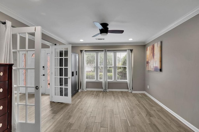 3202 Ivy Station Way, Duluth, GA 30096 - empty room with wood finished floors, baseboards, ceiling fan, crown molding, and french doors