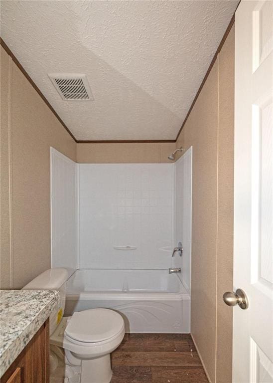 full bathroom featuring vanity, wood-type flooring, a textured ceiling, and ornamental molding