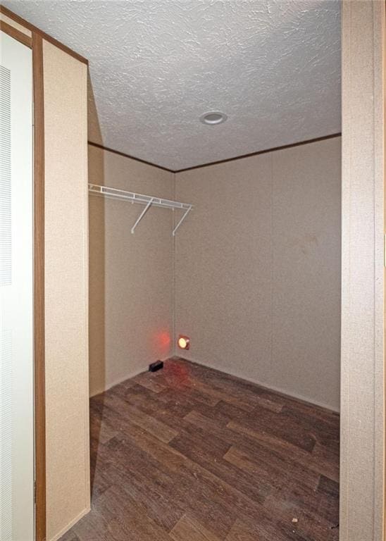 clothes washing area featuring wood-type flooring and a textured ceiling