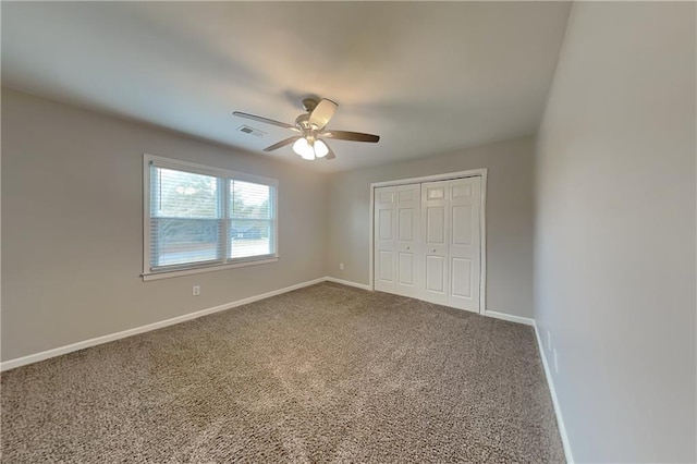 unfurnished bedroom featuring ceiling fan, a closet, and carpet floors