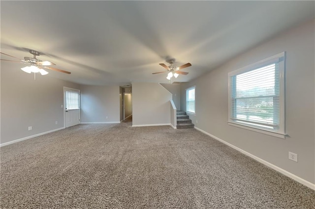 carpeted spare room featuring ceiling fan