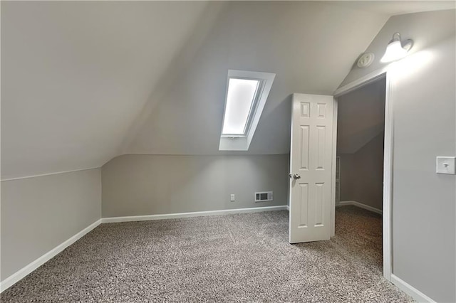 additional living space with vaulted ceiling and carpet