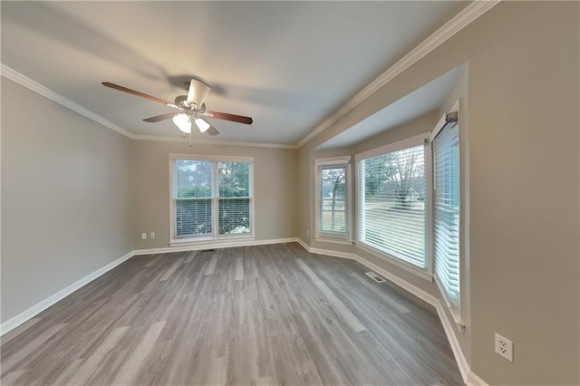 spare room featuring ceiling fan, light hardwood / wood-style flooring, and crown molding