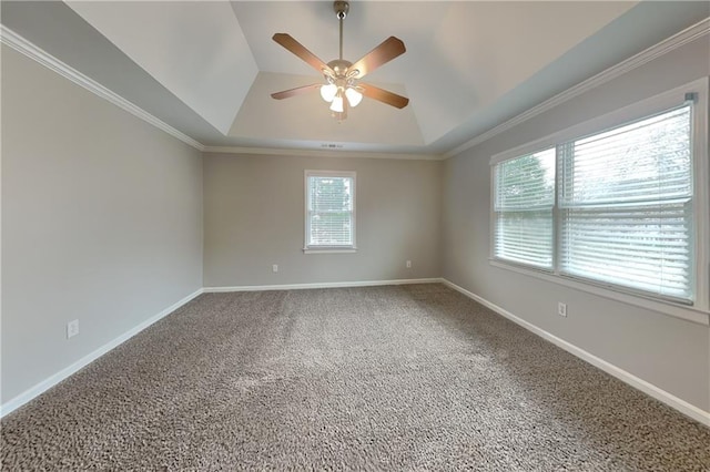 carpeted empty room featuring ceiling fan, crown molding, and a raised ceiling