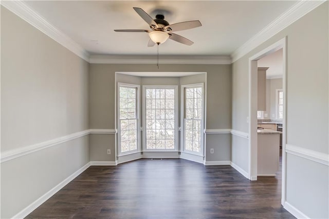 spare room with baseboards, dark wood-style floors, a ceiling fan, and ornamental molding